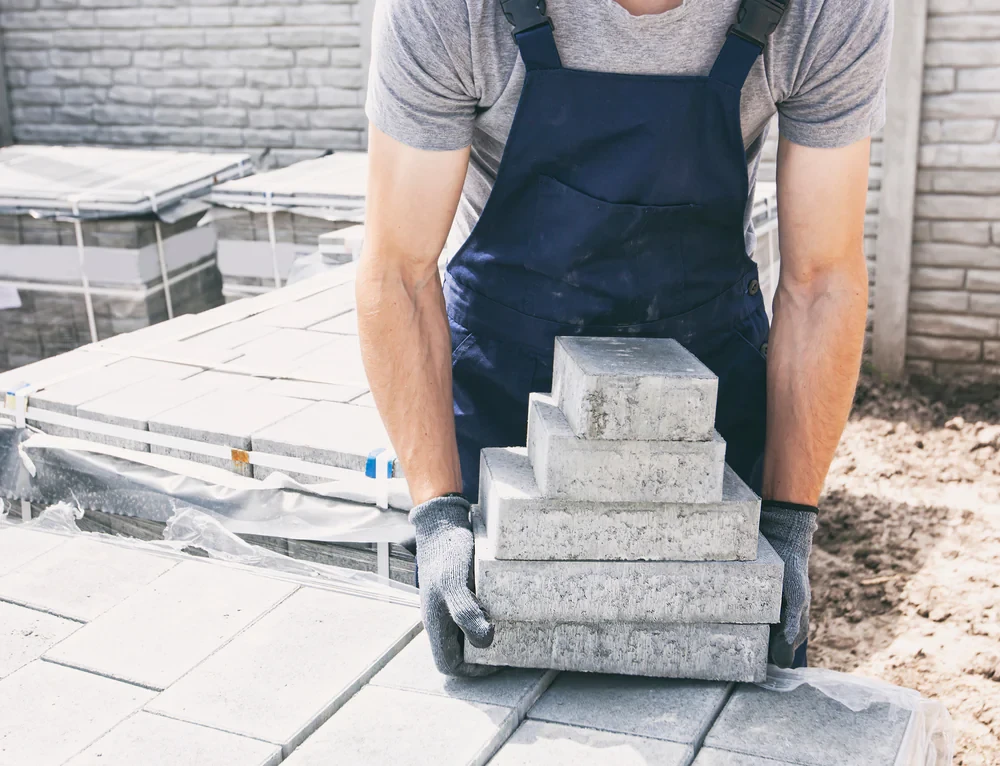 Worker Lifting Paving Stones Suffolk County New York