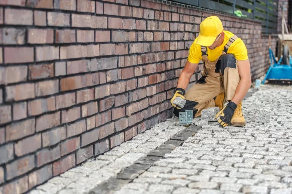 Paving Worker Laying Stones Suffolk County New York